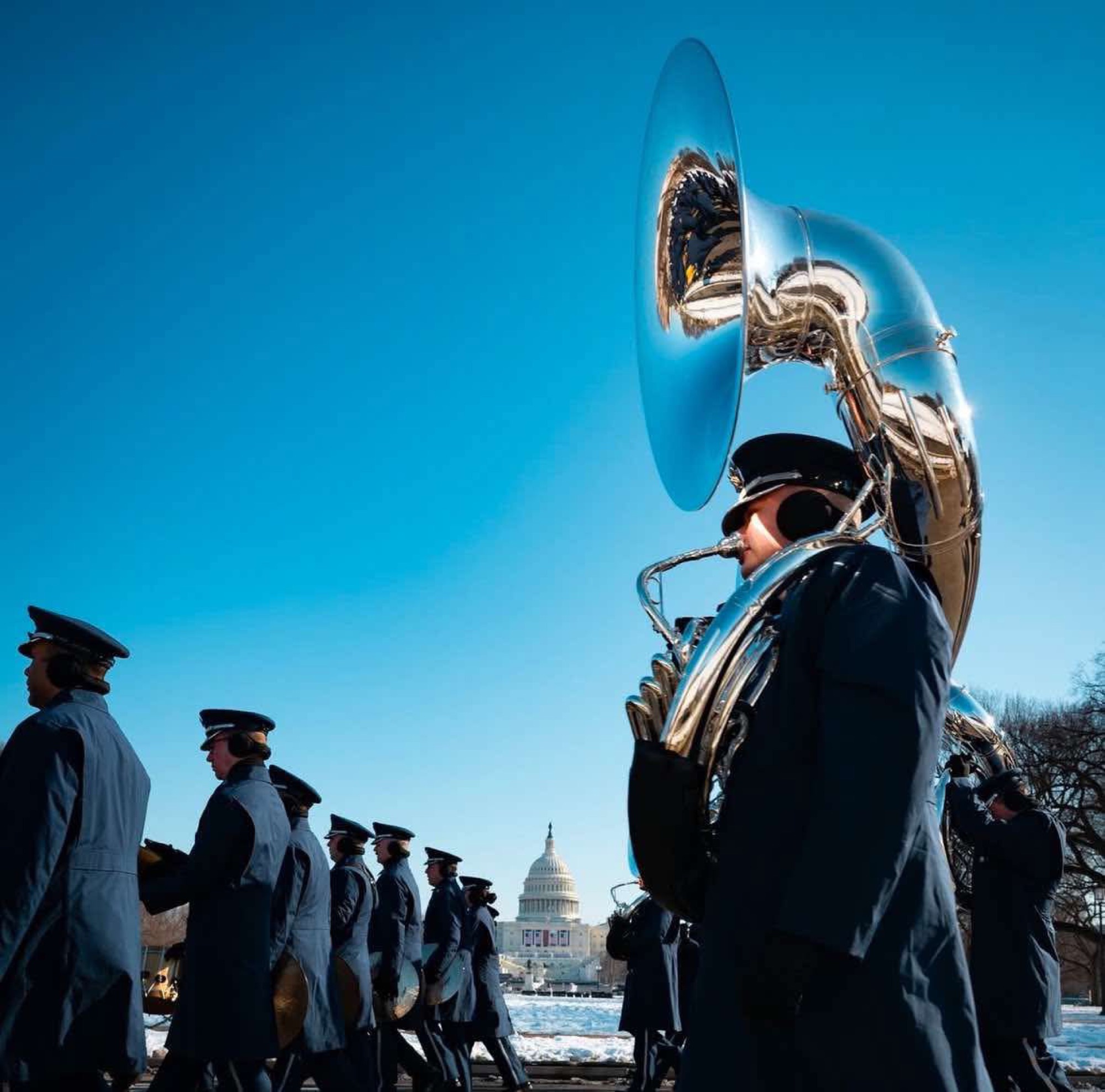 Max Crofton marching with a sousaphone past the United States Capitol.